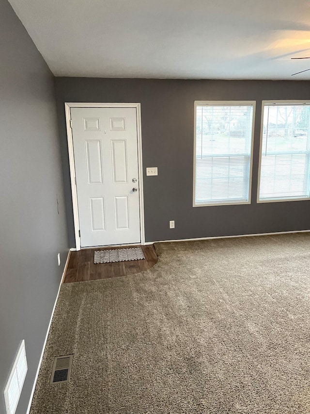 carpeted entrance foyer with ceiling fan