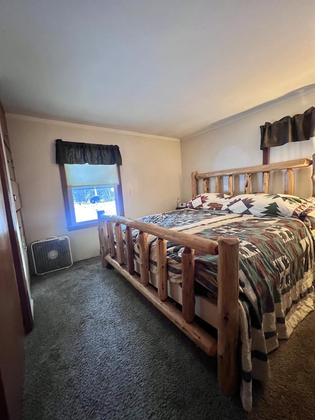 bedroom with dark colored carpet and ornamental molding