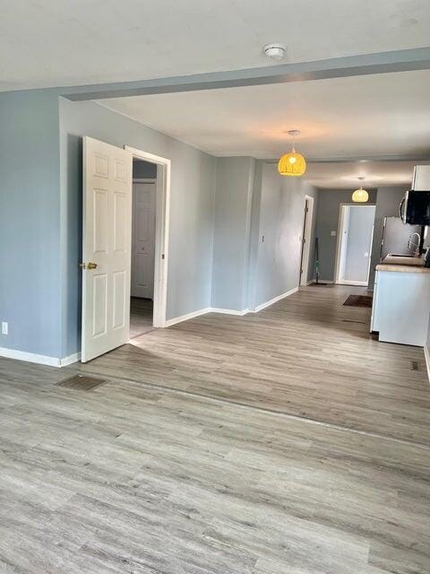 unfurnished room featuring light wood-type flooring