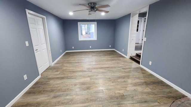 empty room with ceiling fan and hardwood / wood-style floors