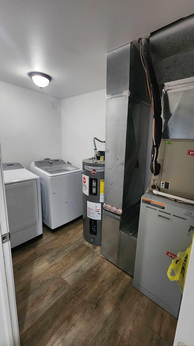 washroom featuring dark hardwood / wood-style flooring, washing machine and dryer, and water heater