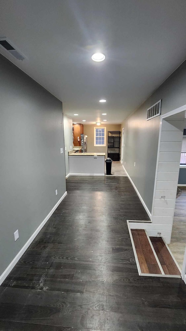 unfurnished living room featuring dark hardwood / wood-style flooring