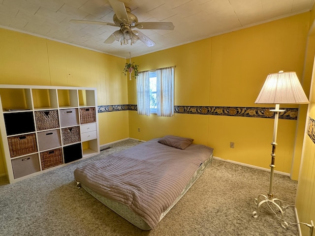 carpeted bedroom with ceiling fan and crown molding