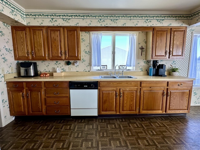 kitchen with dark parquet flooring, dishwasher, sink, and crown molding