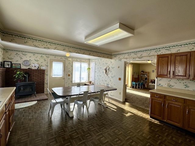 dining room with dark parquet floors and a wood stove