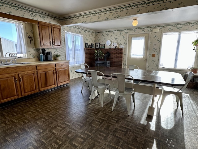 dining room with a wood stove and sink