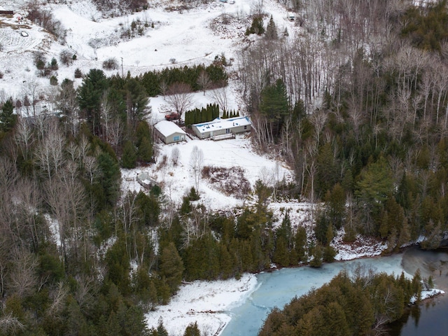 snowy aerial view with a water view