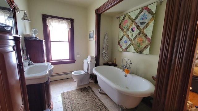 bathroom with vanity, a baseboard heating unit, a bath, tile patterned flooring, and toilet