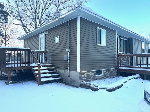 view of snow covered exterior featuring a deck