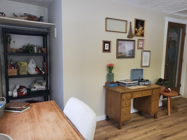 office featuring light hardwood / wood-style flooring and a textured ceiling