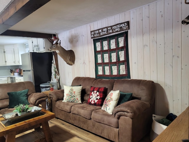 living room featuring hardwood / wood-style floors and wood walls