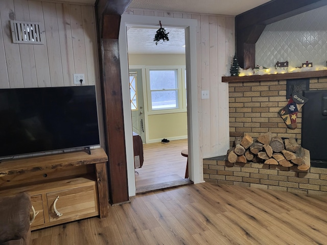 interior space featuring light wood-type flooring and wooden walls