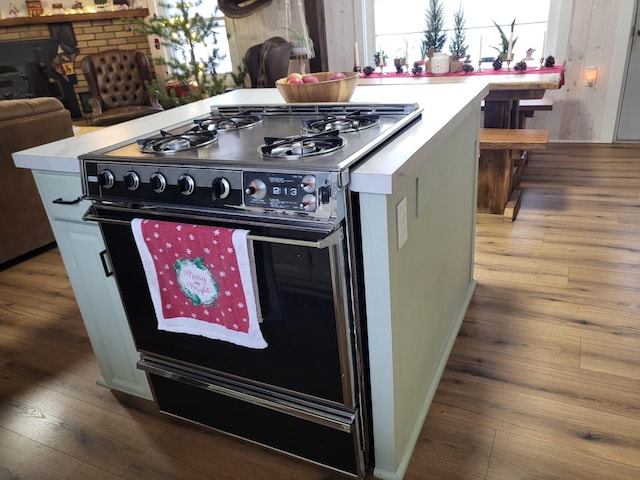 kitchen with a center island, double oven range, and hardwood / wood-style flooring