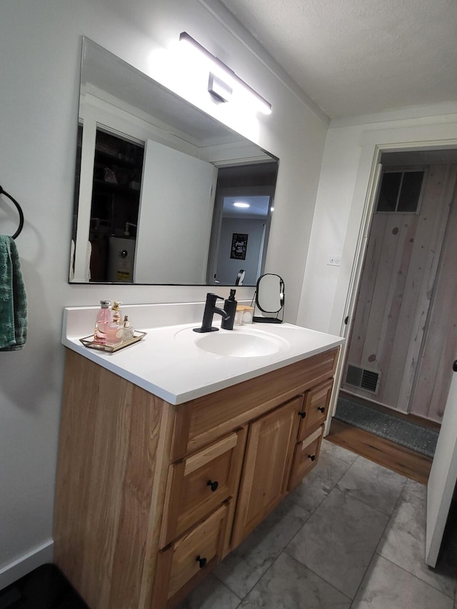 bathroom with vanity and a textured ceiling