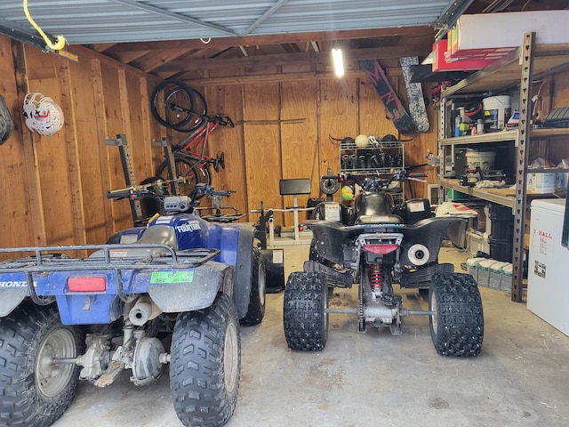 garage featuring wooden walls