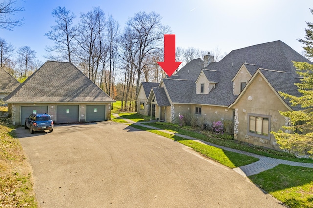 view of front of home with an outbuilding and a garage