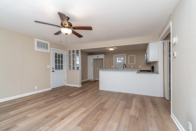 interior space featuring ceiling fan and light hardwood / wood-style flooring