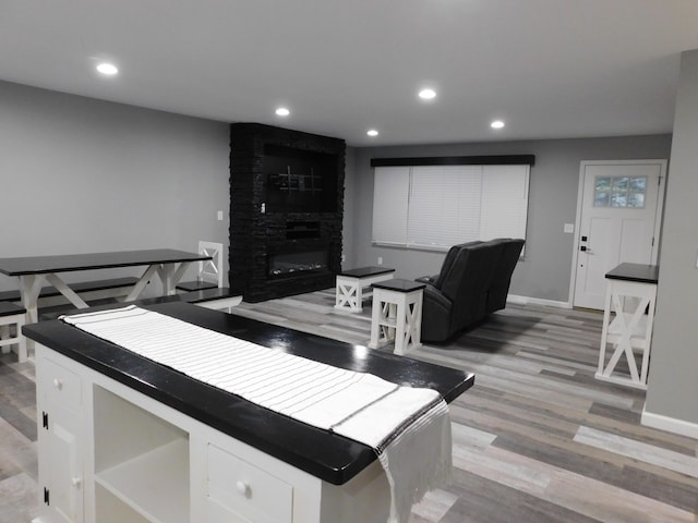 living room with a fireplace and light hardwood / wood-style flooring