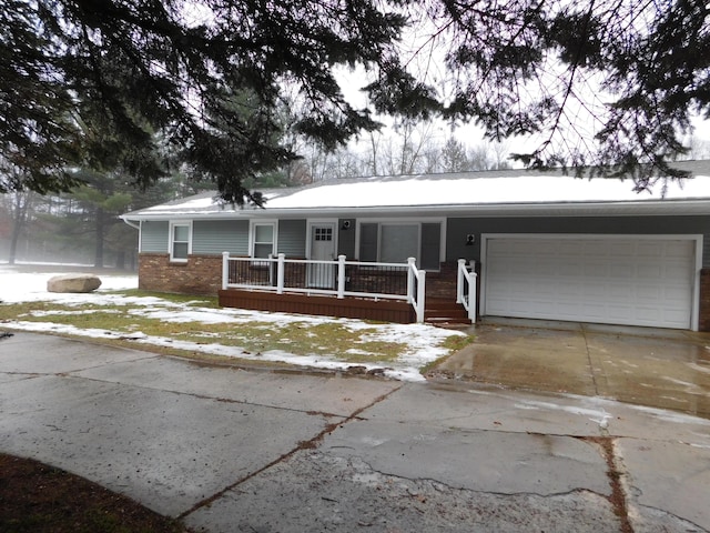 single story home featuring a porch and a garage