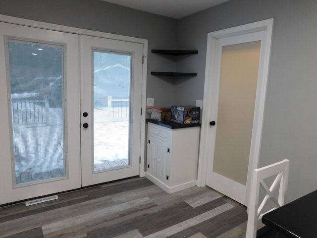 doorway with dark wood-type flooring and french doors