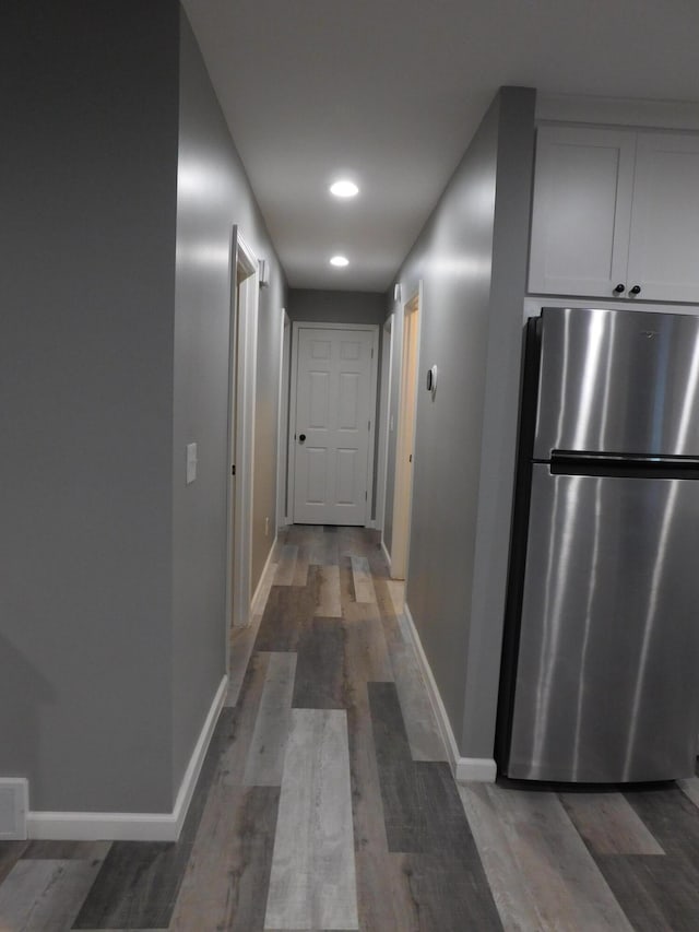 hallway with hardwood / wood-style floors