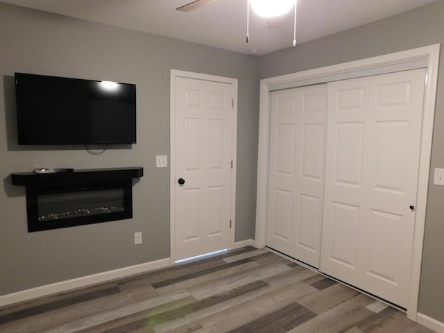 unfurnished bedroom featuring hardwood / wood-style floors and ceiling fan