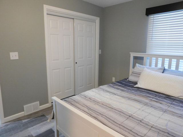 bedroom with hardwood / wood-style flooring and a closet