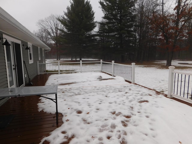 yard layered in snow with a deck