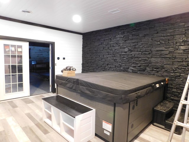 bedroom with wooden ceiling and light hardwood / wood-style floors