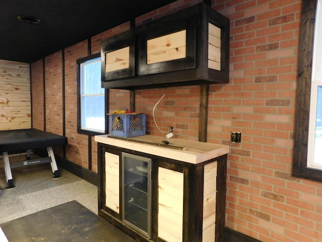 bar featuring carpet and brick wall