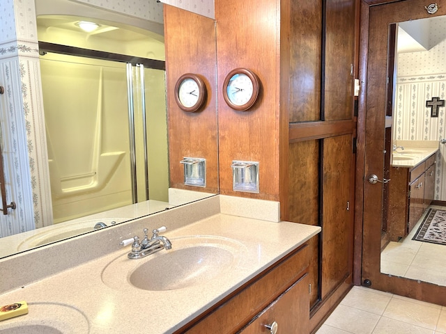 bathroom with tile patterned floors, vanity, and walk in shower