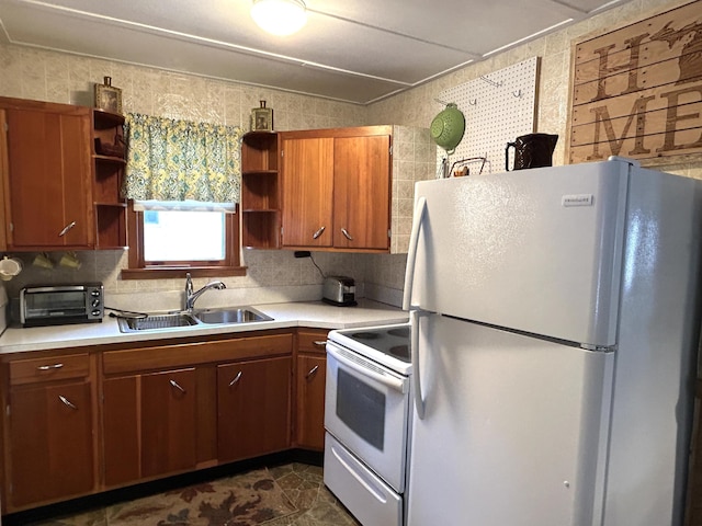 kitchen with white appliances, tile walls, and sink