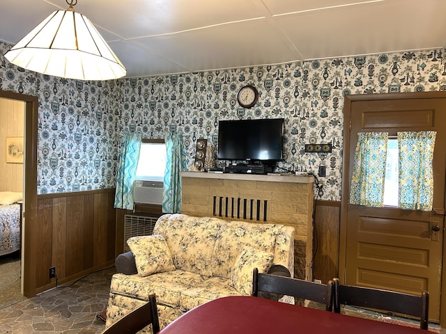 living room featuring cooling unit and wooden walls