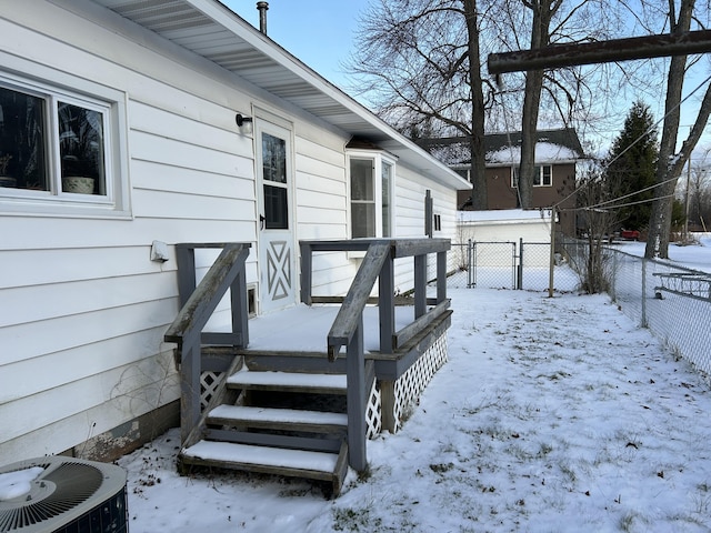 snow covered deck featuring cooling unit