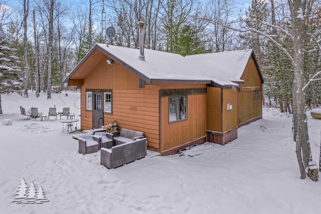 snow covered property featuring an outdoor hangout area