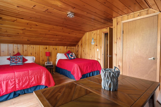 bedroom featuring wood walls, wood-type flooring, lofted ceiling, and wooden ceiling