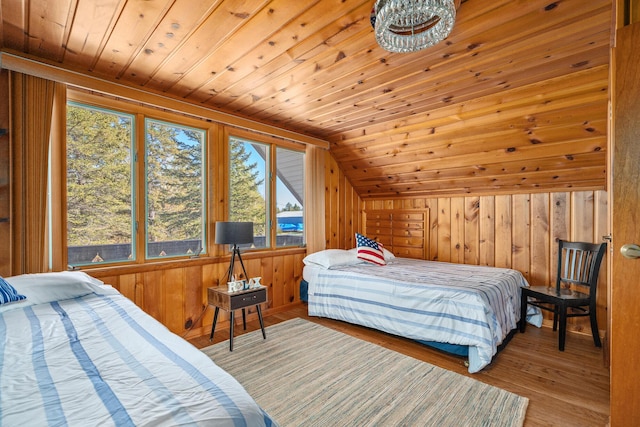 bedroom featuring hardwood / wood-style floors, wood walls, wood ceiling, and vaulted ceiling