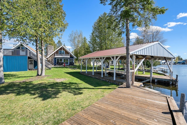 view of dock featuring a lawn and a water view