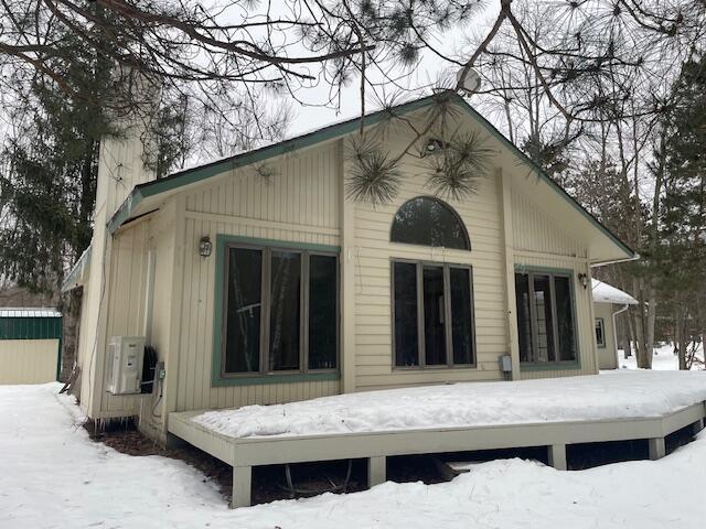 view of snow covered rear of property