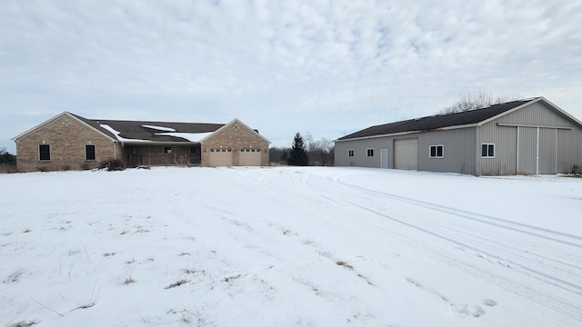 yard layered in snow featuring a garage