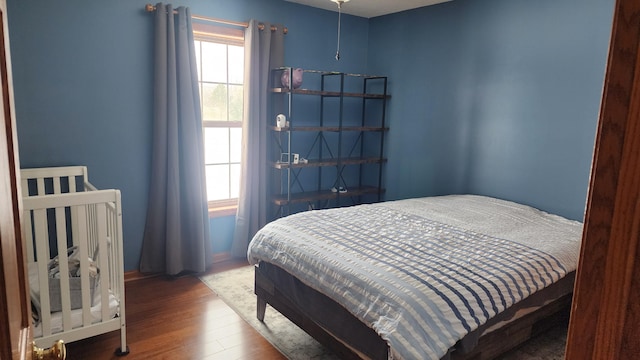 bedroom with dark wood finished floors