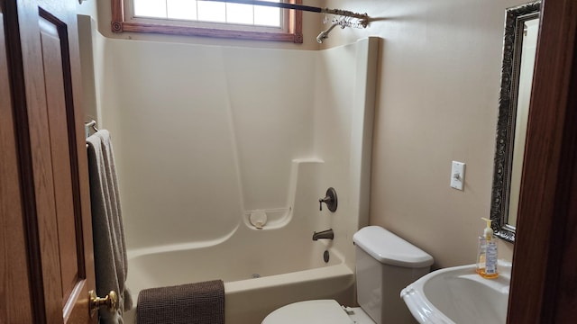 bathroom featuring toilet and shower / bathtub combination