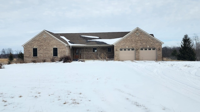 single story home with a garage and brick siding