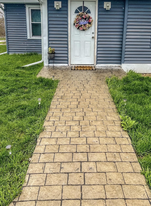 entrance to property with a yard