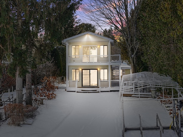 back house at dusk with a balcony