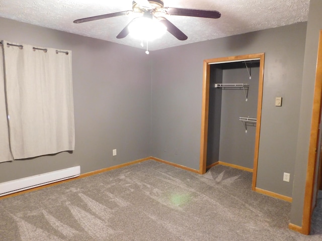 unfurnished bedroom with carpet flooring, ceiling fan, a textured ceiling, and a closet