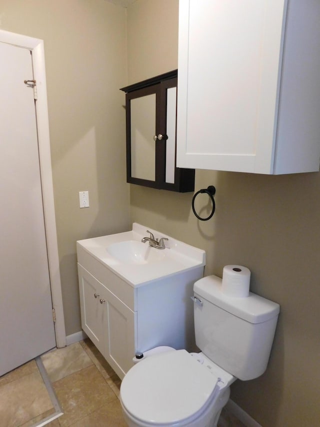 bathroom with tile patterned floors, vanity, and toilet