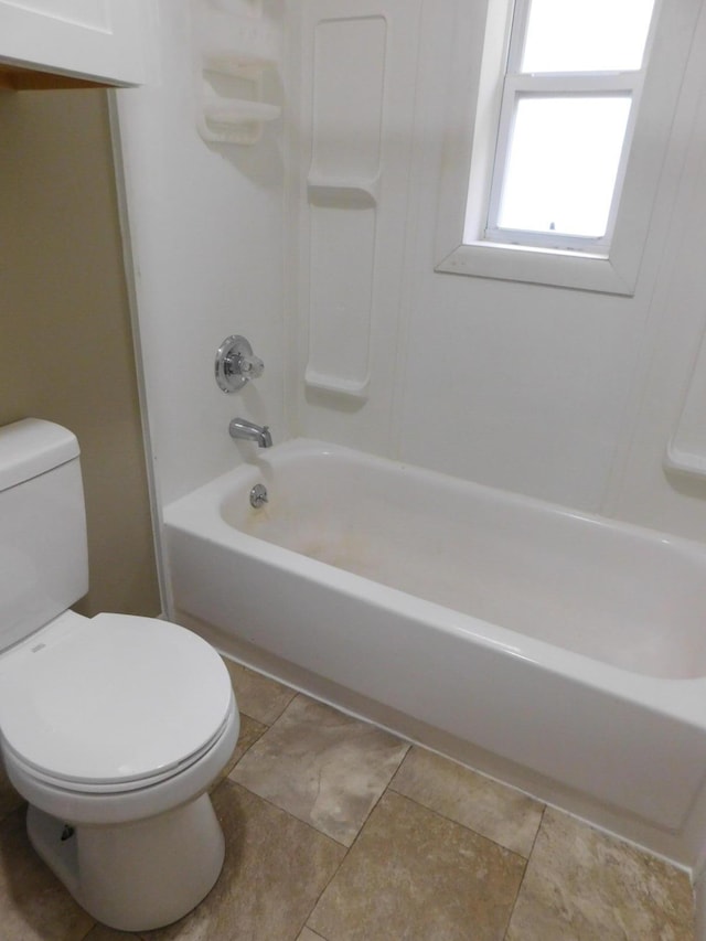 bathroom with toilet and shower / washtub combination