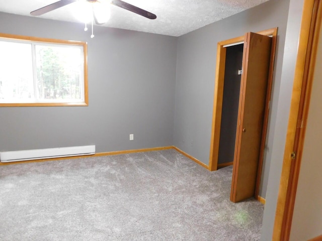 unfurnished room with carpet, a textured ceiling, a baseboard radiator, and ceiling fan