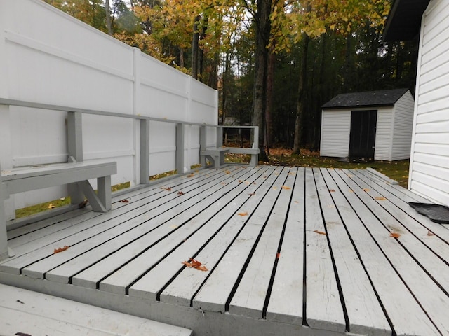 wooden deck featuring a storage shed